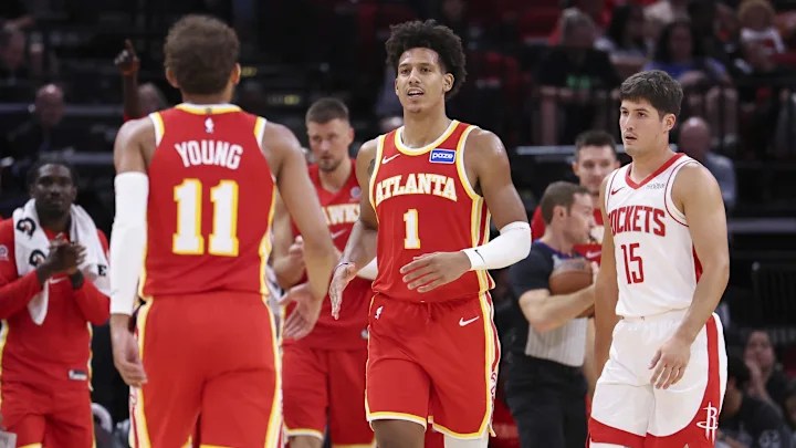 Trae Young and Jalen Johnson celebrating after the Houston Rockets call a timeout.