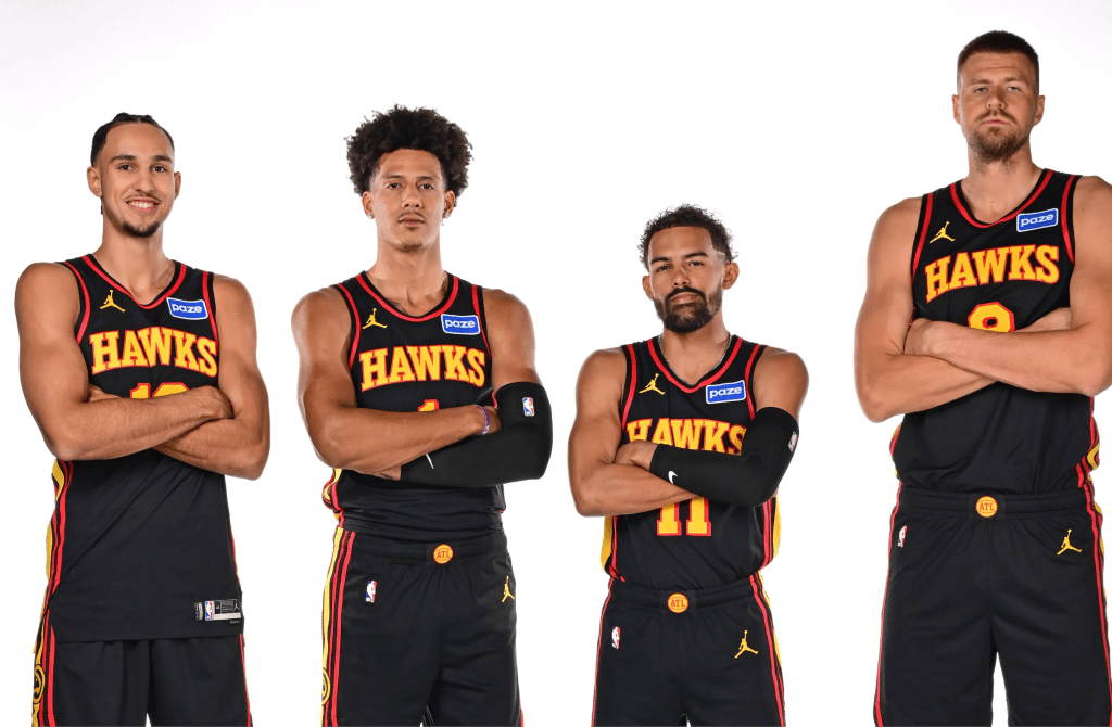 From left to Right: Zaccharie Risacher, Jalen Johnson, Trae Young, and Kristaps Porzingis posing for a photo